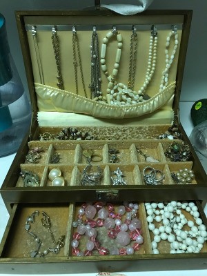 A jewelry box with a collection of different types of jewelry.