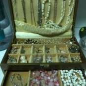 A jewelry box with a collection of different types of jewelry.