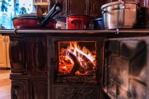 A wood burning stove in the kitchen.