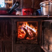 A wood burning stove in the kitchen.