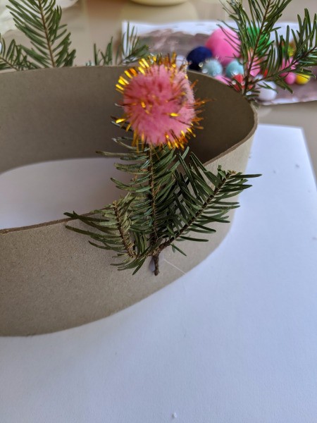 Christmas Tree Hat - pink and gold pom pom on small piece of greenery