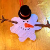 Melted Snowman Ornament - melted snowman ornament on light wood surface