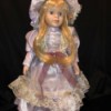 Identifying a Porcelain Doll - doll wearing a lace and satin dress and matching hat