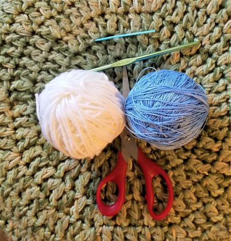Crocheted Pouch with Lanyard for Crafting Supplies - white yarn and blue crochet thread with scissors, hook, and needle