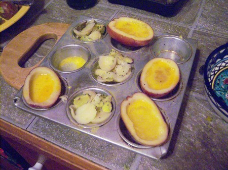 Eggs in Potato Halves & cut seasoned potatoes in muffin tin