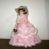 Information on a Brinn Plastic and Fabric Doll - doll wearing long full pink dress with white lace trim
