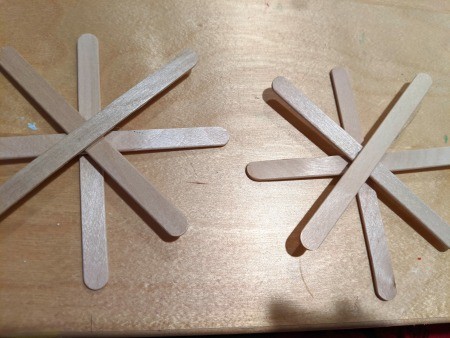 Making Popsicle Stick Snowflake Ornaments - two snowflakes made from 4 sticks