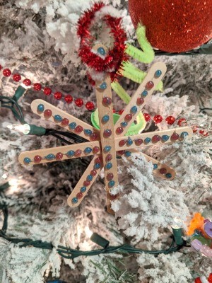 Making Popsicle Stick Snowflake Ornaments - ornament on the tree