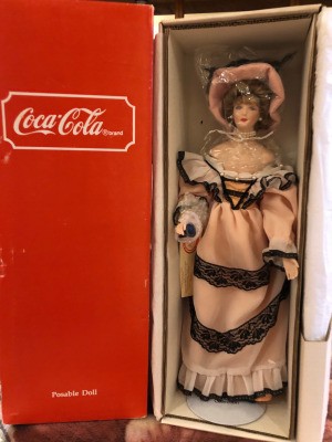 Value of a Coca Cola Heritage Doll - doll in box wearing a Victorian era dress and hat