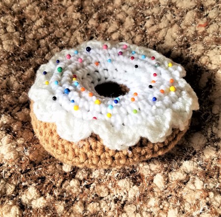 Crocheted Donut Pincushion - icing in place with pins randomly stuck in place