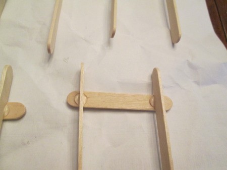 Popsicle Stick Sled - glue long ones on edge near the ends of a short stick