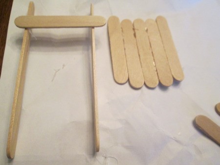 Popsicle Stick Sled - glue the 5 short sticks as shown with a curve
