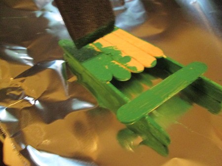 Popsicle Stick Sled - painting the green sled