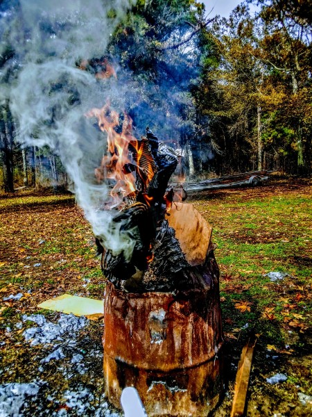 A smoky fire in a burn barrel.