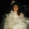 Identifying a Geppeddo Doll - dark haired doll wearing a white lace trimmed dress