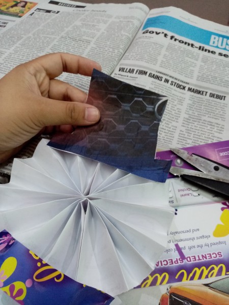 Wiggly Paper Snowman - cut a hat from a black section of a magazine page and glue in place