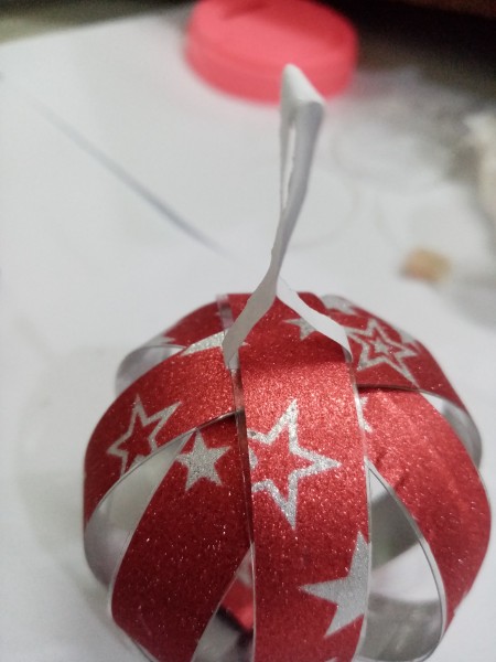 Recycled Plastic Bottle Christmas Balls - adding a hanger to the red ball