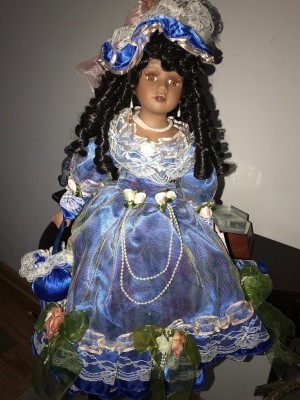 Value of a Crimson Collection Porcelain Doll - doll wearing a blue satin dress with white lace