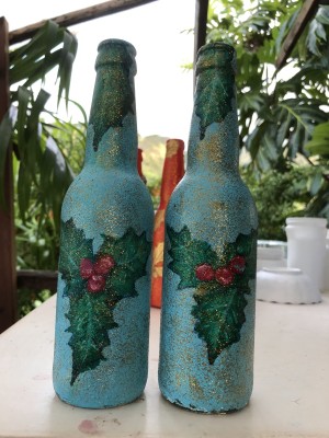 Recycled Bottle Holly Leaf Candlestick Holder - two blue bottles with holly leaves painted on to use as candleholders