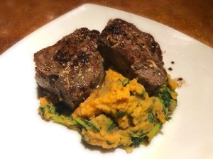 Lamb Loin Chops with Garlic Brandy Butter with sweet potaoes on plate