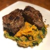 Lamb Loin Chops with Garlic Brandy Butter with sweet potaoes on plate