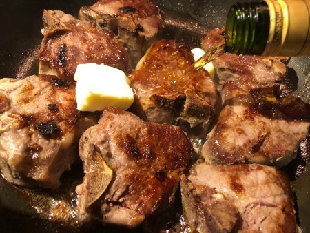 Adding brandy & butter to chops in pan