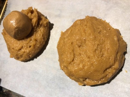 frozen Peanut Butter ball on and one covered with cookie dough