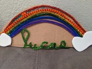 Rainbow Name Room Decor - green pipe cleaner shaped into child's name glued below the rainbow