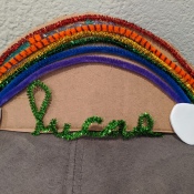 Rainbow Name Room Decor - green pipe cleaner shaped into child's name glued below the rainbow