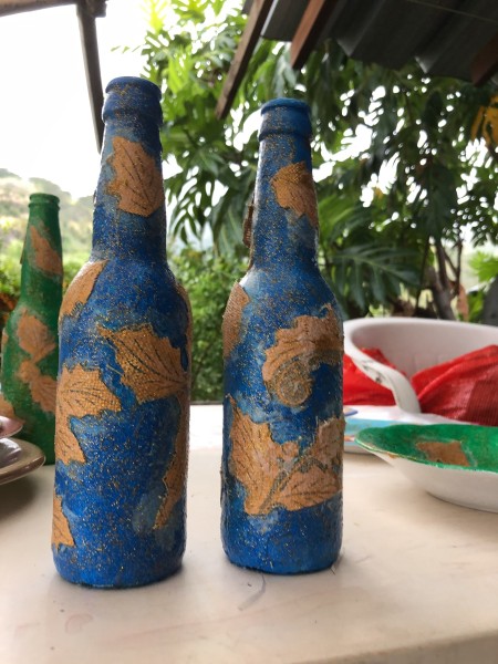 Recycled Bottle Gold Leaf Candlestick Holders - two decorated blue bottles with gold leaf decorations