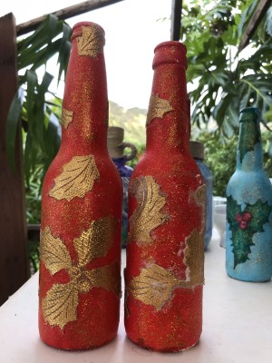 Recycled Bottle Gold Leaf Candlestick Holders - two red bottles with gold leaf elements