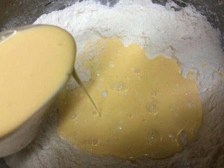 adding eggnog to flour
