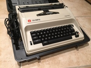 Repairing an Olympia Reporter Electric Typerwriter - typewriter in a case