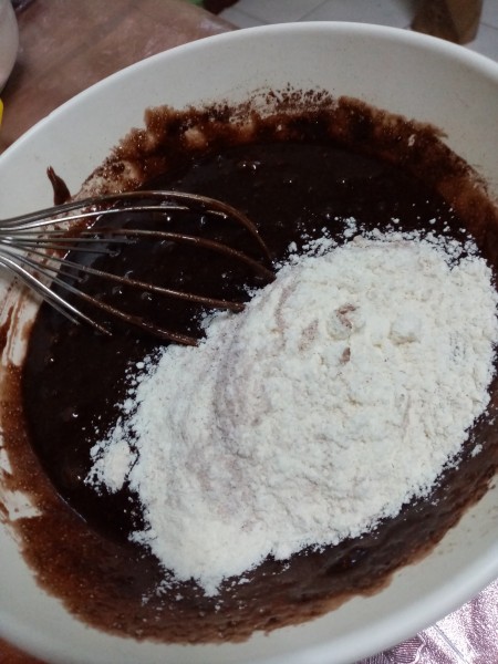 adding flour to batter