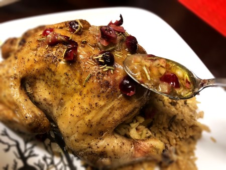 spooning sauce over Hens