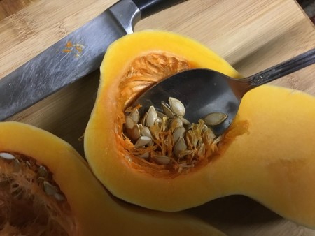 scouping seeds from Butternut Squash