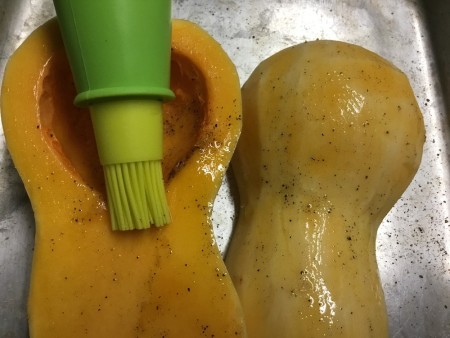brushing Butternut Squash with butter salt & pepper