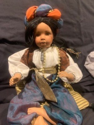 Identifying a Porcelain Doll - doll wearing a headdress, blouse, vest, and pants