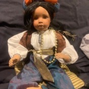 Identifying a Porcelain Doll - doll wearing a headdress, blouse, vest, and pants