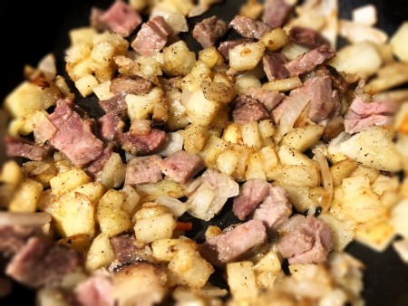 Steak added to potatoes