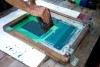 Screen Printing Tips And Tricks - person's hands working on a screen print