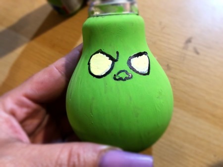 Light Bulb Grinch Ornament - closeup of eyes and nose