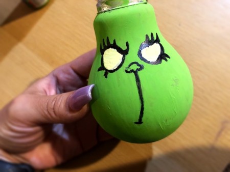 Light Bulb Grinch Ornament - draw a curved line down from the nose and add eye lashes