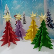 Colorful Paper Mini Table Top Christmas Tree - 4 colorful trees in front of a snowy backdrop
