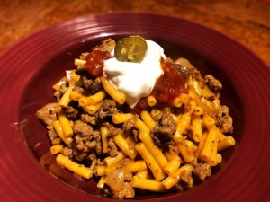 Taco Mac n Cheese topped with sour cream & salsa