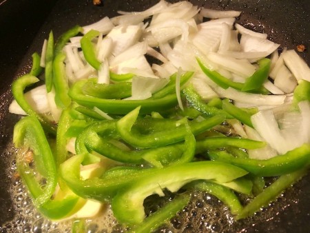 adding Onion and Pepper to pan