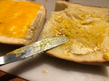spreading mustard on bread