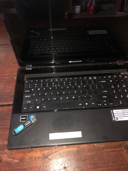 Replacing Your Laptop Hard Drive - laptop with a USB flash drive lying on the keyboard