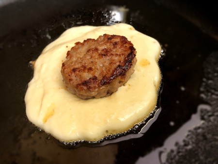sausage on top of cooking pancake