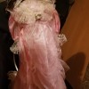 Value of a Knightsbridge Collection Porcelain Doll - doll wearing a pink dress and matching hat, both trimmed with white lace